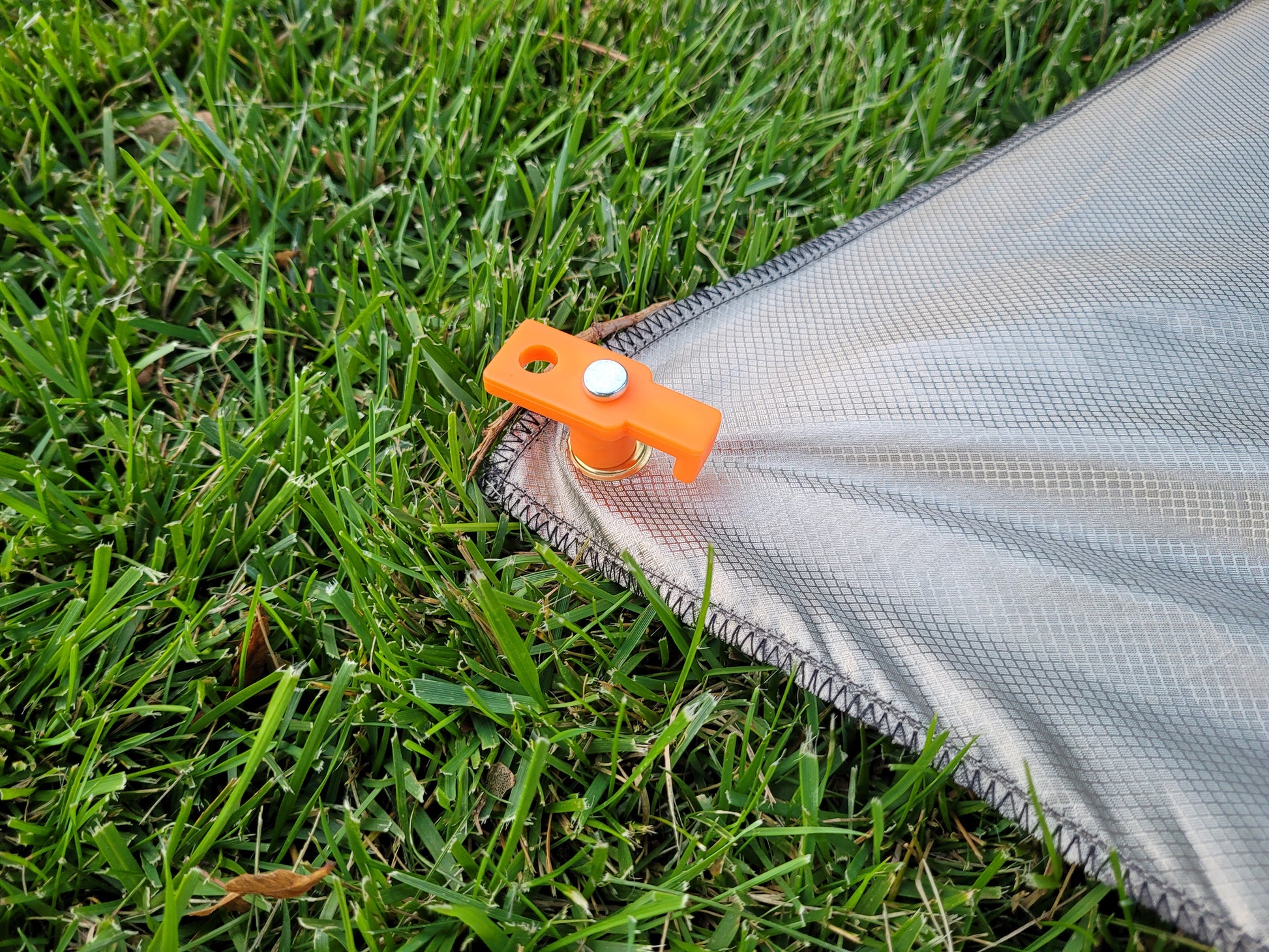 5/16 Brass Gromet in corner of Oz Faraday Cloth staked to the ground