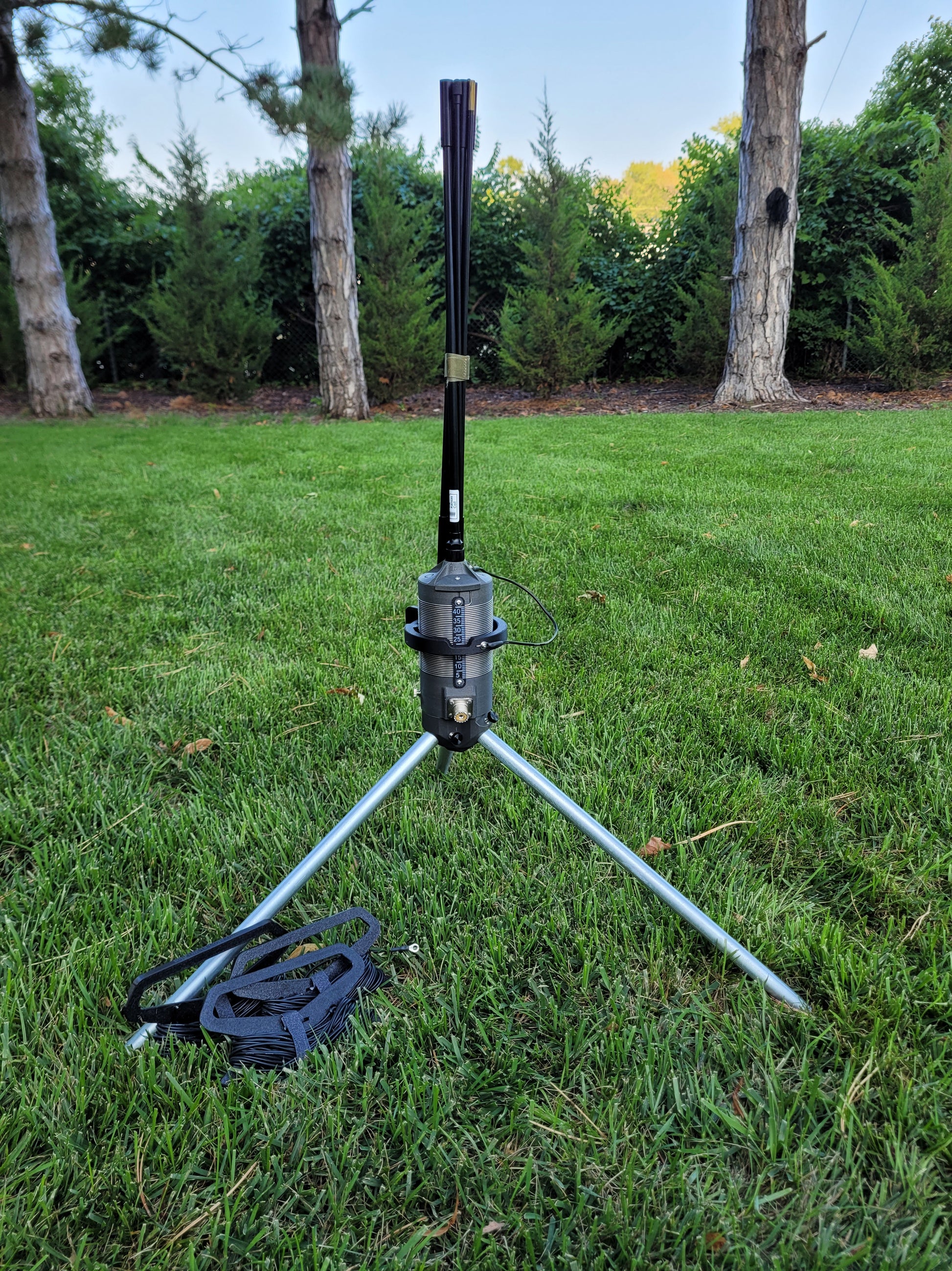 Coil sitting on deployed tripod with collapsed whip and wire radials